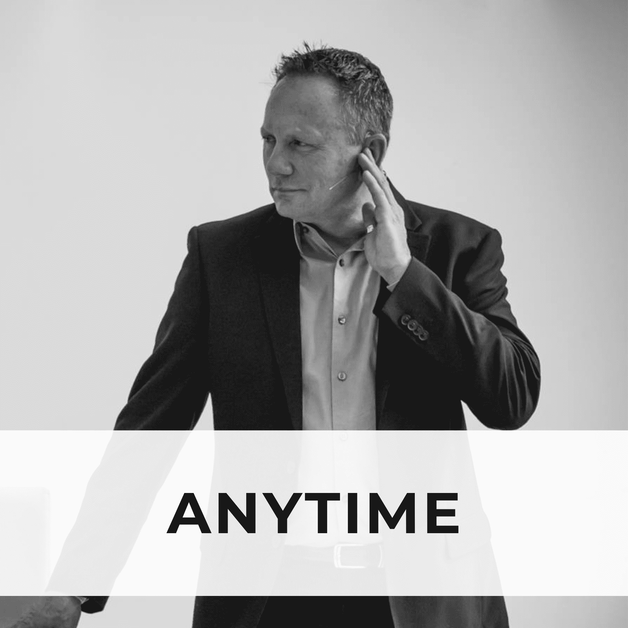 Robert Gene Smith dressed in a suit and tie gestures with his hand to his ear, showcasing the tapping method used in FasterEFT.